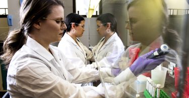 Woman in lab coat working in a lab